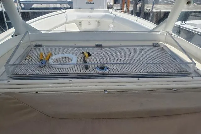 Slide: The Image of 2015 Sailfish 270 CC boat interior seating with cup holders and white upholstery. - 14