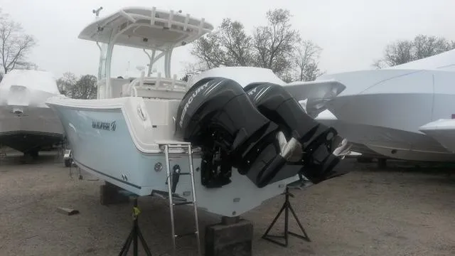 Slide: The Image of Interior of 2015 Sailfish 270 CC boat, featuring compact marine toilet and storage. - 16