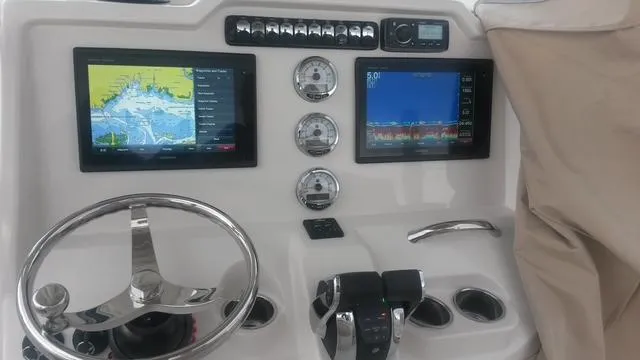 Slide: The Image of 2015 Sailfish 270 CC boat with twin Verado 200 engines in a marina setting. - 3