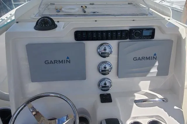 Slide: The Image of 2015 Sailfish 270 CC boat cockpit with Garmin navigation system and fishing rod holders. - 5