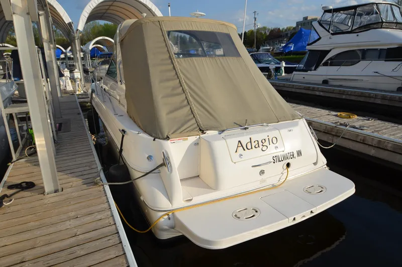 Slide: The Image of 2001 Sea Ray 310 Sundancer docked, covered, with "Adagio" name visible. - 12