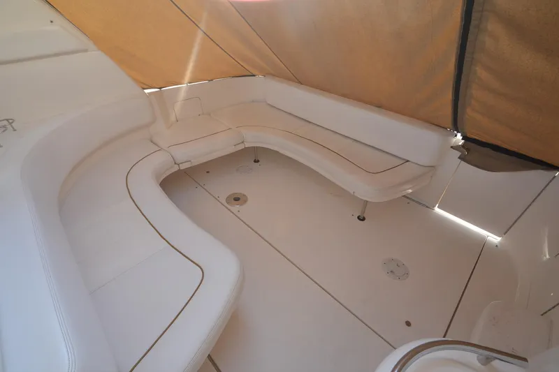 Slide: The Image of 2001 Sea Ray 310 Sundancer boat interior with white seating and tan canopy. - 15