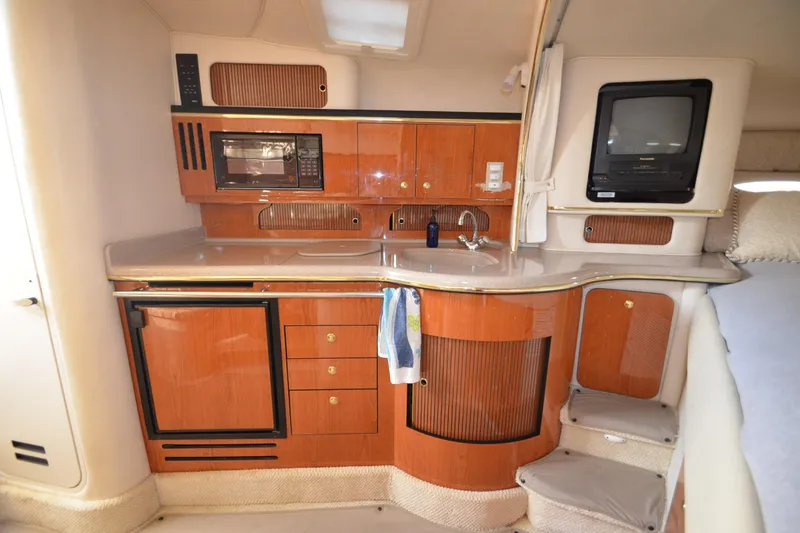 Slide: The Image of 2001 Sea Ray 310 Sundancer interior with kitchenette, microwave, and TV. - 20