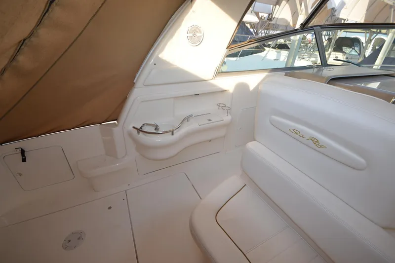 Slide: The Image of 2001 Sea Ray 310 Sundancer interior with white seating and compact sink area. - 7