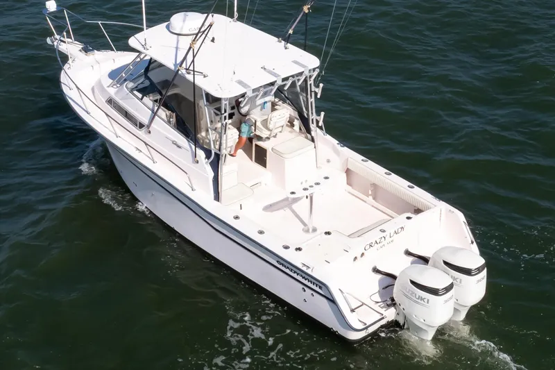 Slide: The Image of 1997 Grady-White Marlin 300 cruising on open water, showcasing sleek design and performance. - 1