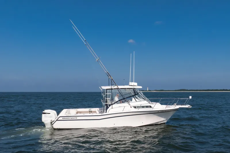 Slide: The Image of 1997 Grady-White Marlin 300 boat cruising on open water. - 15