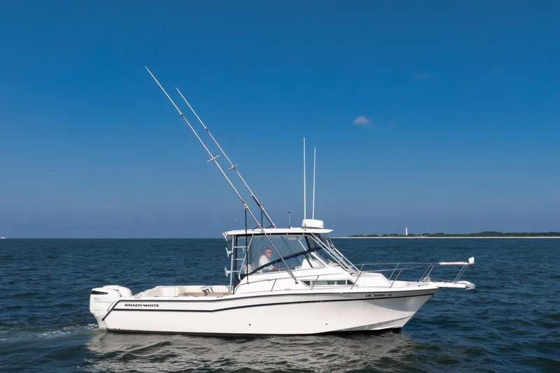 Slide: The Image of 1997 Grady-White Marlin 300 boat cruising on open water. - 17