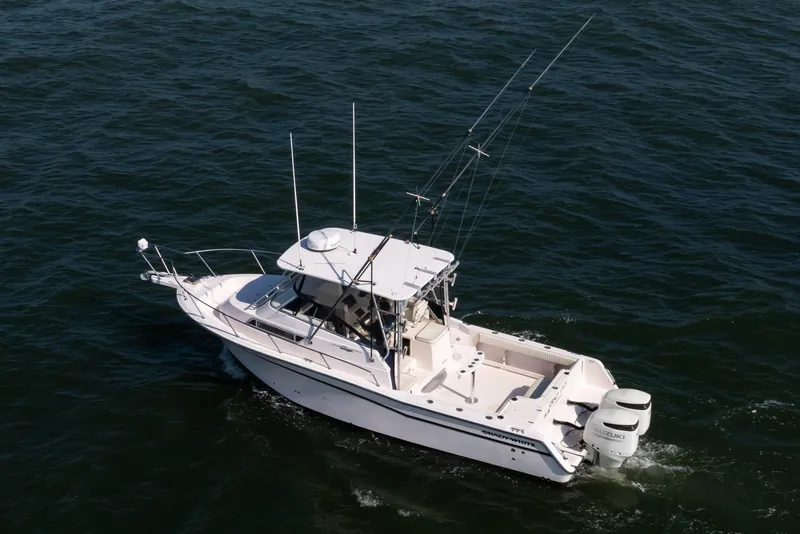 Slide: The Image of 1997 Grady-White Marlin 300 boat cruising on open water. - 3