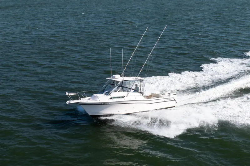 Slide: The Image of 1997 Grady-White Marlin 300 boat on open water with clear blue sky. - 32