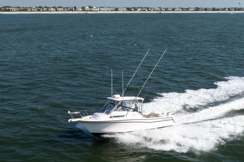Slide: The Image of 1997 Grady-White Marlin 300 boat on open water under clear blue sky. - 33