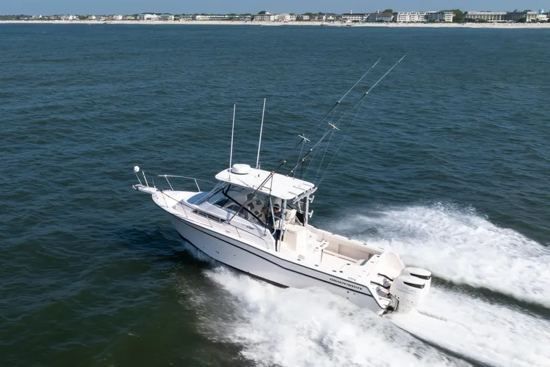 Slide: The Image of 1997 Grady-White Marlin 300 boat on open water under clear blue sky. - 45