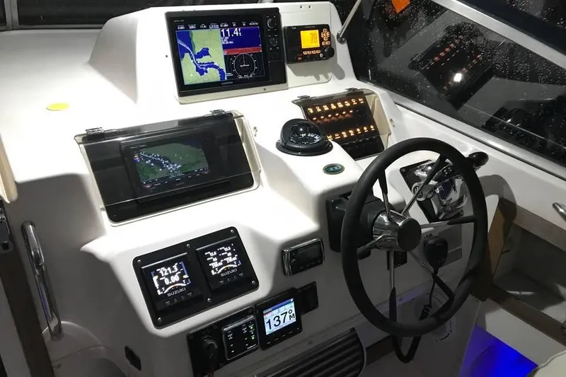 Slide: The Image of 1997 Grady-White Marlin 300 boat on open sea with clear blue sky. - 46