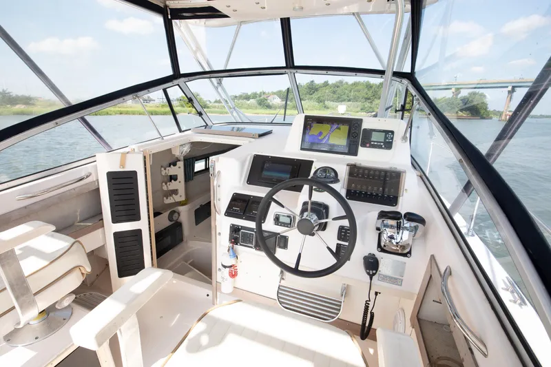 Slide: The Image of 1997 Grady-White Marlin 300 boat cruising on open water. - 49