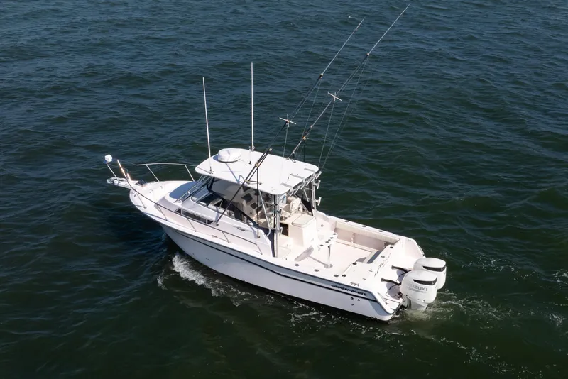 Slide: The Image of 1997 Grady-White Marlin 300 boat cruising on open water. - 5
