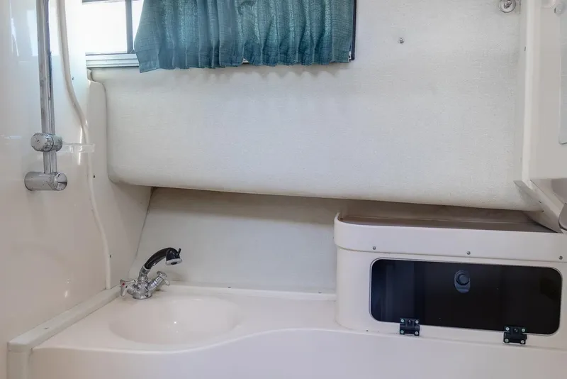 Slide: The Image of 1997 Grady-White Marlin 300 boat deck with seating, ocean view, and fishing rod holders. - 58