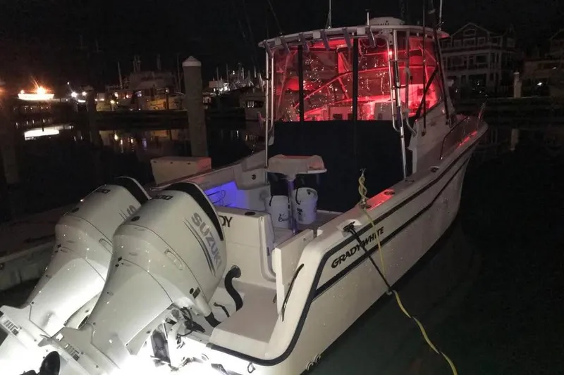 Slide: The Image of 1997 Grady-White Marlin 300 boat cockpit with steering wheel and navigation equipment. - 59