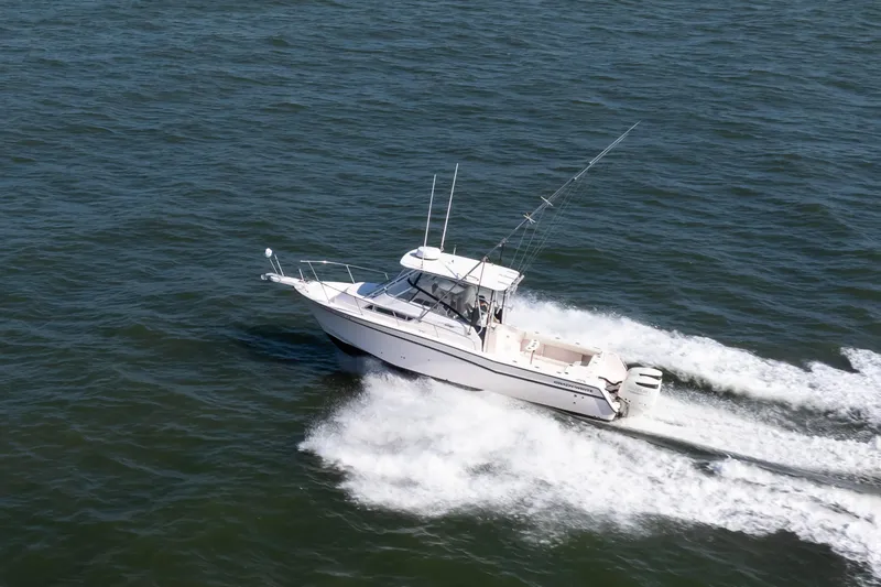 Slide: The Image of 1997 Grady-White Marlin 300 boat cruising on open water. - 6