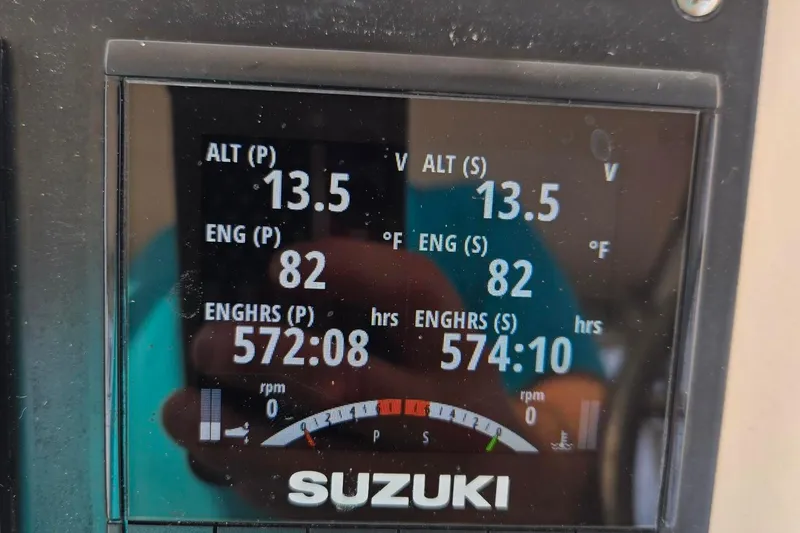 Slide: The Image of 1997 Grady-White Marlin 300 cabin interior with blue seating and natural light. - 60