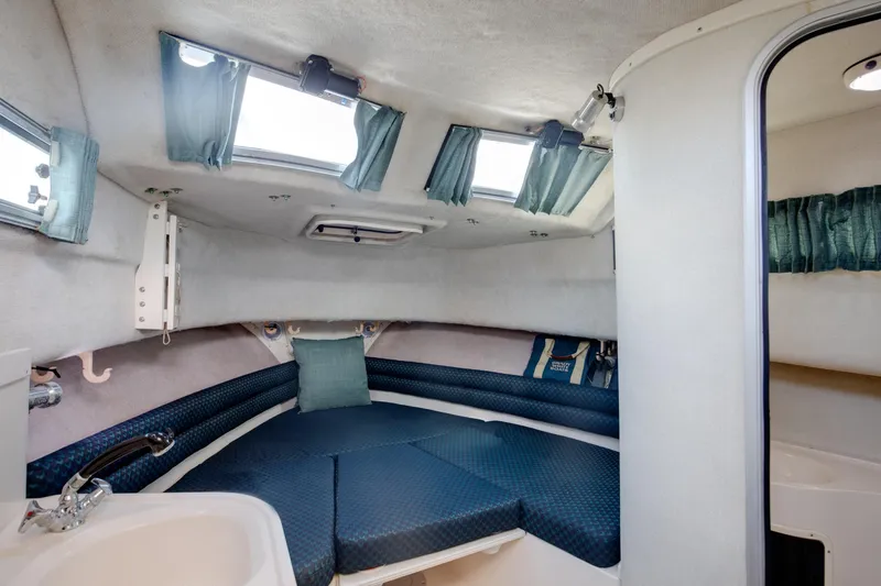 Slide: The Image of 1997 Grady-White Marlin 300 cabin interior with blue seating and windows. - 62