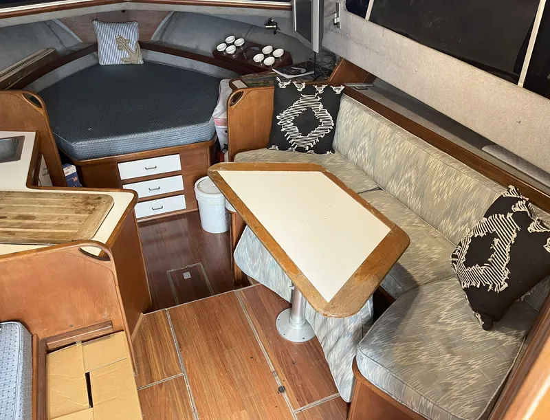 Slide: The Image of Interior of a 1988 Pacemaker 308 boat with cozy seating and wooden accents. - 11