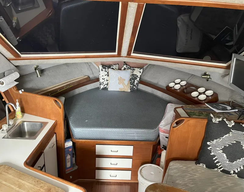 Slide: The Image of Cozy interior of a 1988 Pacemaker 308 boat with seating, sink, and nautical decor. - 15