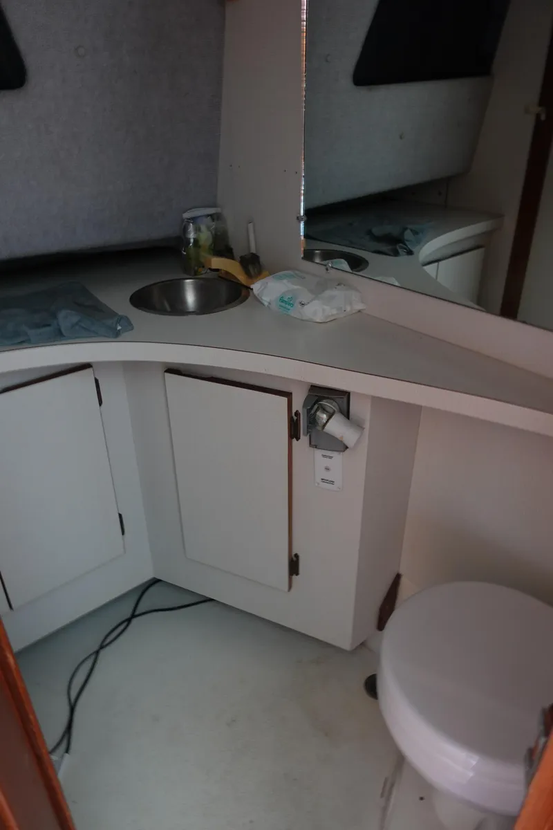 Slide: The Image of 1988 Pacemaker 308 boat interior with sink, cabinets, and toilet. - 18