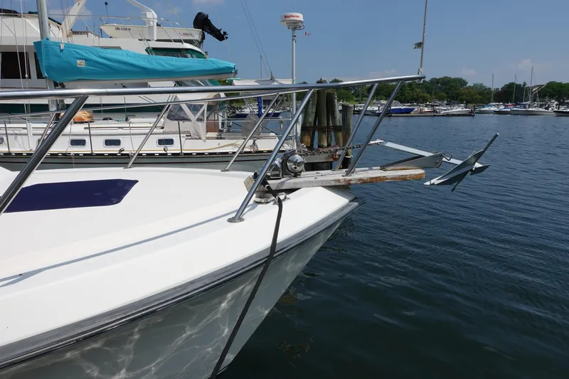 Slide: The Image of 1988 Pacemaker 308 boat docked at marina with visible anchor and railing. - 2