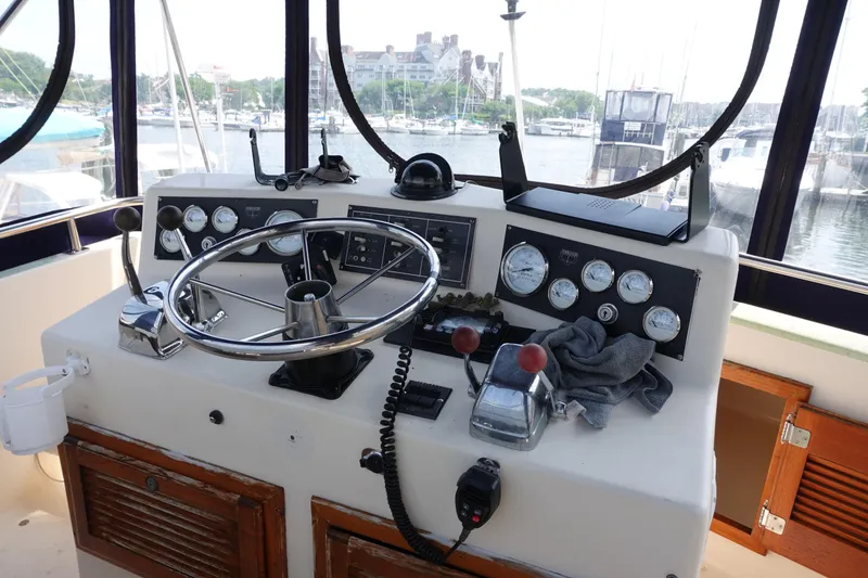 Slide: The Image of 1988 Pacemaker 308 boat helm with steering wheel and control gauges at marina. - 6