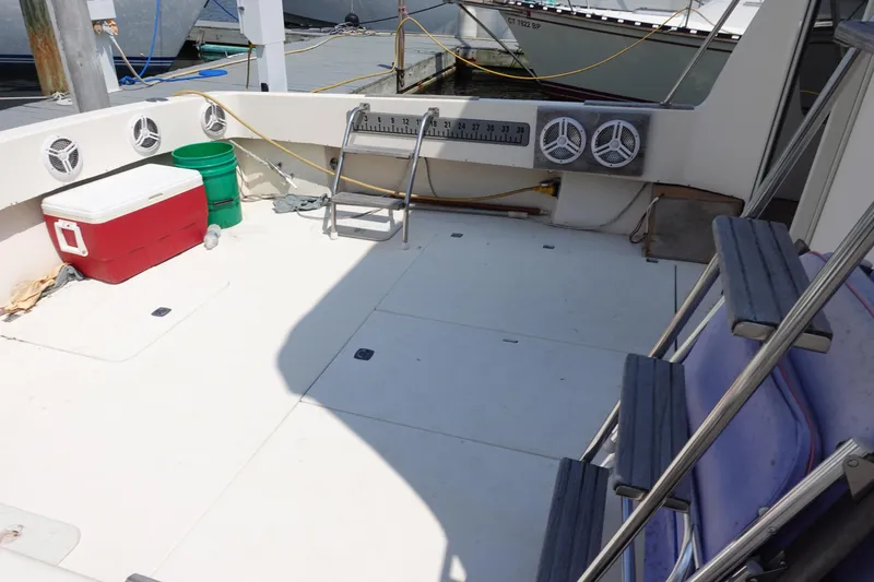 Slide: The Image of 1988 Pacemaker 308 boat deck with cooler, speakers, and ladder at marina. - 8