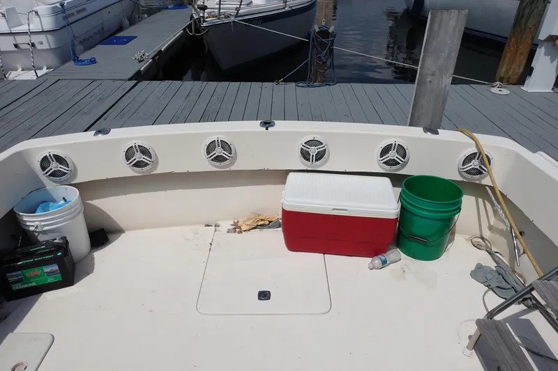 Slide: The Image of Boat deck with speakers, cooler, and buckets; Pacemaker 308, 1988 model at dock. - 9