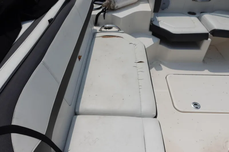 Slide: The Image of 2016 Sea Ray SPX 190 Outboard interior with worn white seating. - 10