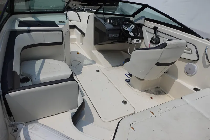 Slide: The Image of 2016 Sea Ray SPX 190 Outboard boat interior with white seating and steering console. - 7