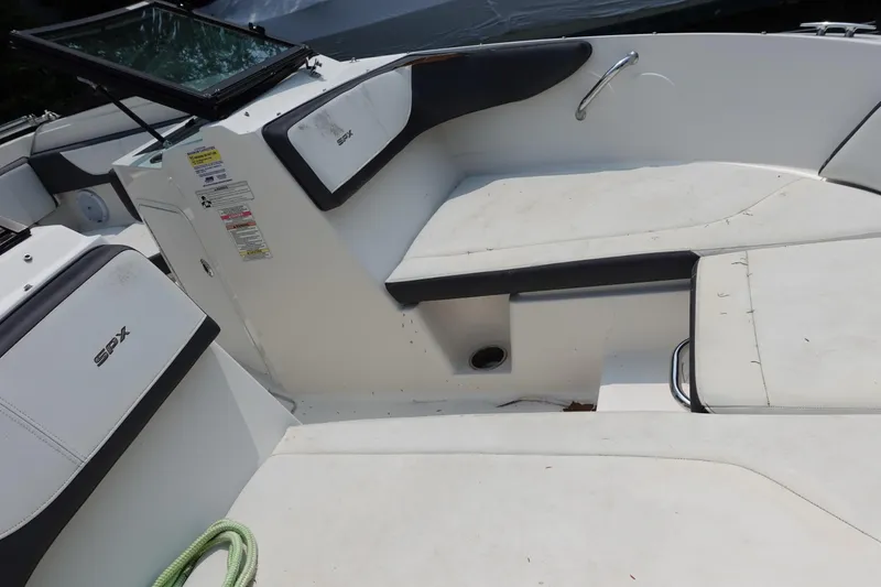Slide: The Image of 2016 Sea Ray SPX 190 Outboard boat interior with white seating and black accents. - 9