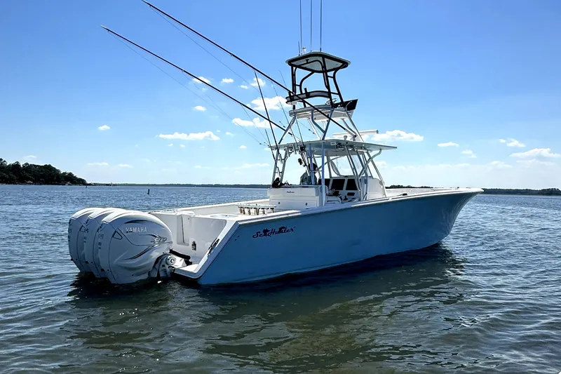 The Image of 2015 SeaHunter 41 Tournament boat on calm water under clear blue sky. - 1