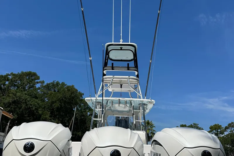 Slide: The Image of 2015 SeaHunter 41 Tournament boat with triple engines against a clear blue sky. - 10