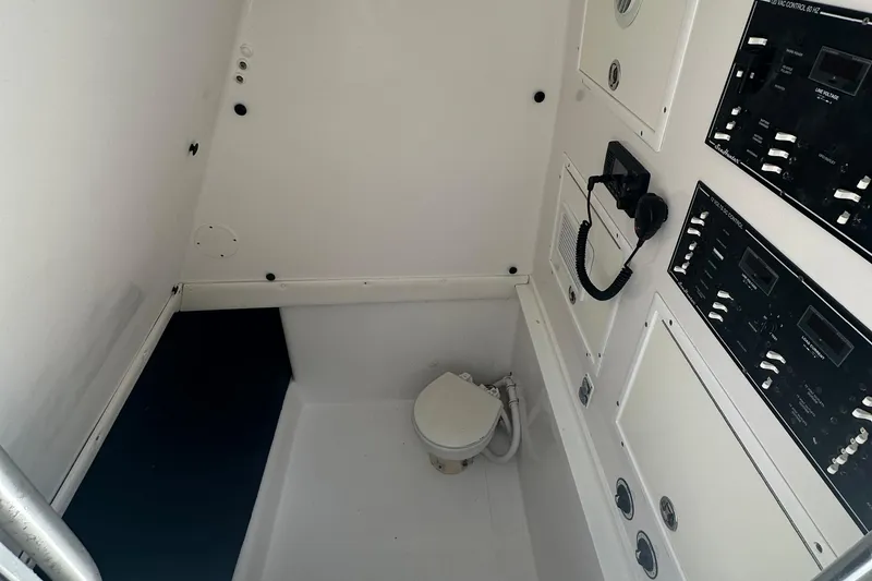 Slide: The Image of 2015 SeaHunter 41 Tournament boat interior with control panels and compact toilet. - 3