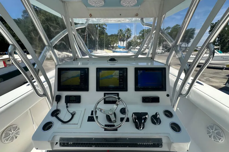 Slide: The Image of 2015 SeaHunter 41 Tournament boat dashboard with navigation screens and steering wheel. - 9