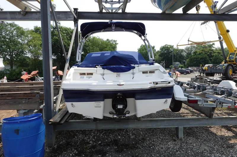 Slide: The Image of 2013 Chaparral 19 Sport H2O boat on trailer, covered and parked outdoors. - 3