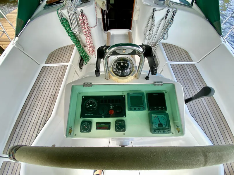 Slide: The Image of Cockpit of a 1999 Beneteau 411 sailboat with navigation instruments and compass. - 10