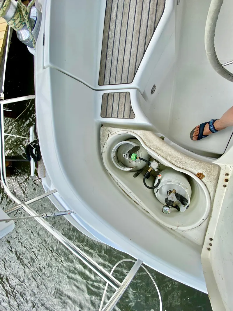 Slide: The Image of 1999 Beneteau 411 yacht deck with propane tank and foot visible. - 11