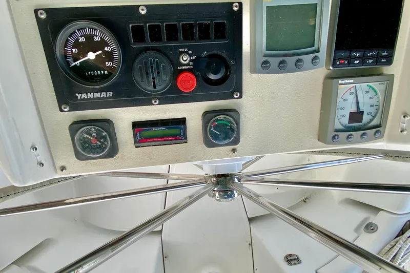 Slide: The Image of Control panel of a 1999 Beneteau 411 sailboat with Yanmar engine gauges. - 12