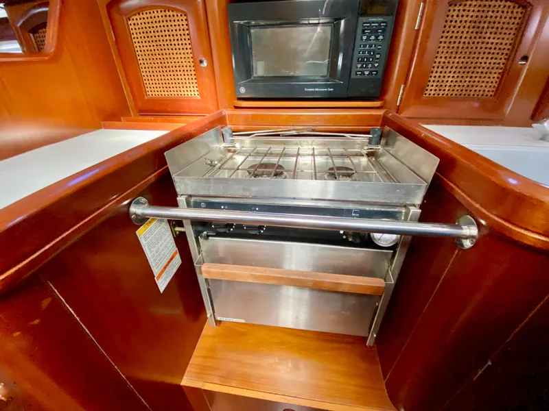 Slide: The Image of Galley kitchen in 1999 Beneteau 411 yacht with stove and microwave. - 13
