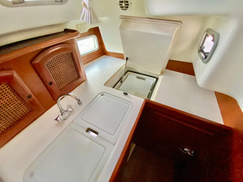 Slide: The Image of Interior of 1999 Beneteau 411 sailboat kitchen with sink and storage. - 14