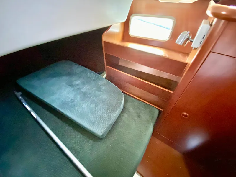Slide: The Image of Interior cabin of a 1999 Beneteau 411 sailboat with wooden shelves and seating. - 19