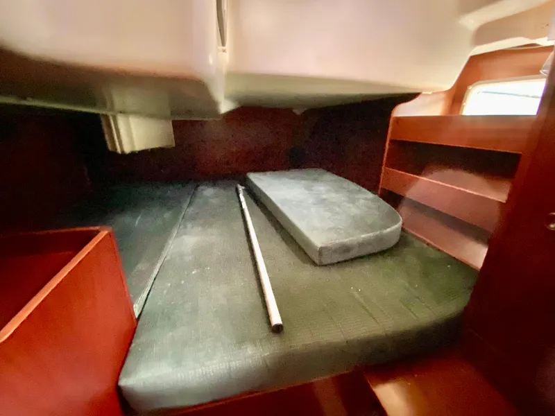 Slide: The Image of Interior cabin of 1999 Beneteau 411 sailboat with wooden shelves and mattress. - 21