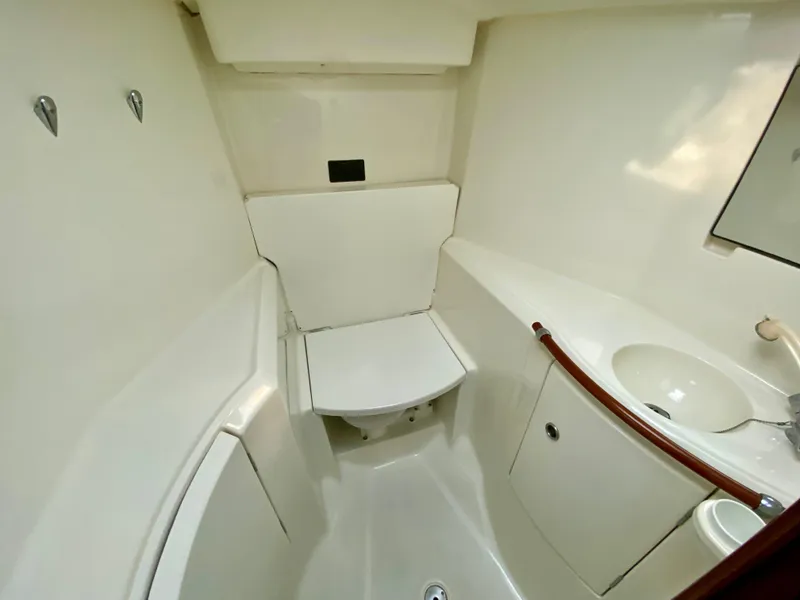Slide: The Image of Bathroom interior of 1999 Beneteau 411 yacht, featuring compact design and white fixtures. - 28