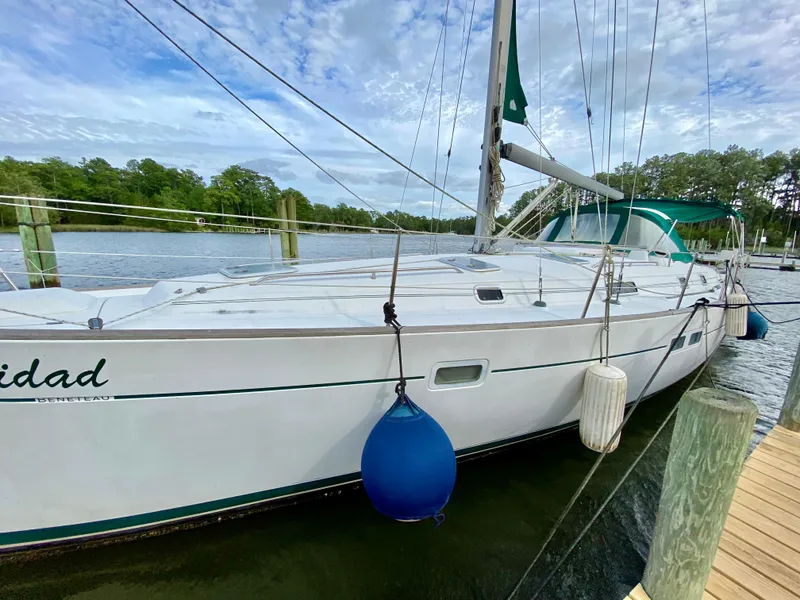 Slide: The Image of Sailboat docked at marina, 1999 Beneteau 411, with blue and white fenders. - 5