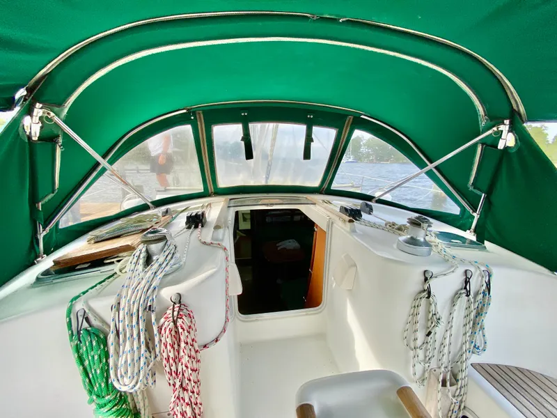 Slide: The Image of Interior view of a 1999 Beneteau 411 sailboat with green canopy and ropes. - 6
