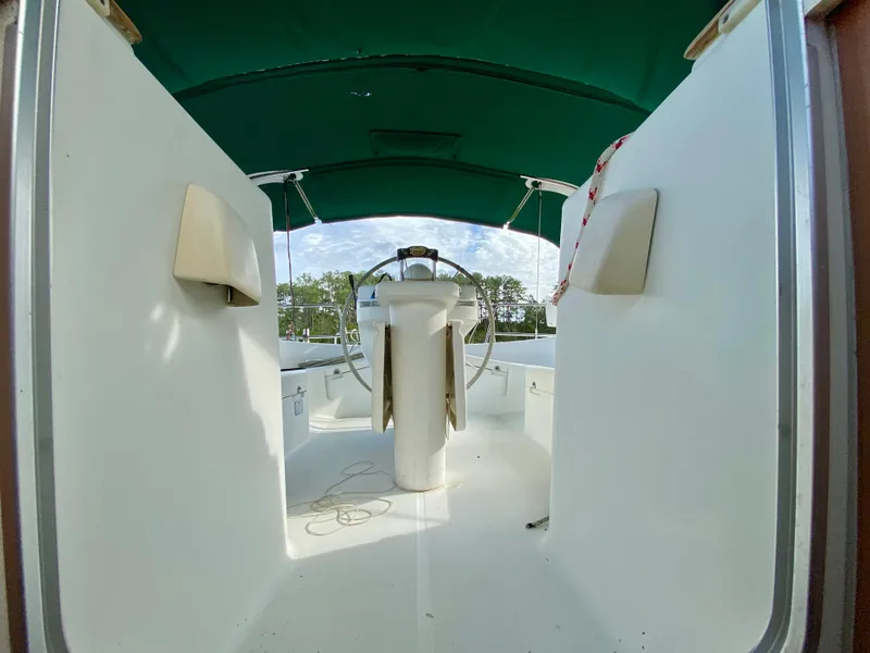 Slide: The Image of Cockpit of 1999 Beneteau 411 sailboat with green canopy and steering wheel. - 8