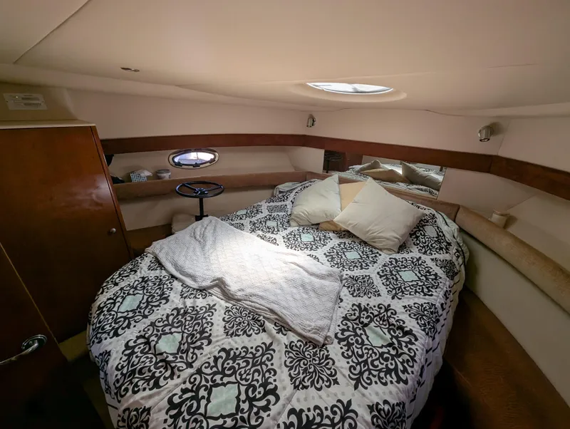 Slide: The Image of Luxurious 2006 Meridian 368 yacht bedroom with patterned bedding and cozy lighting. - 10